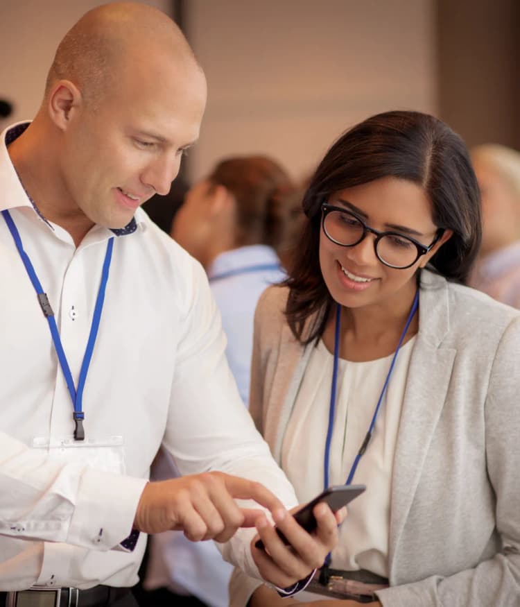 Two people checking a digital business card on the phone
